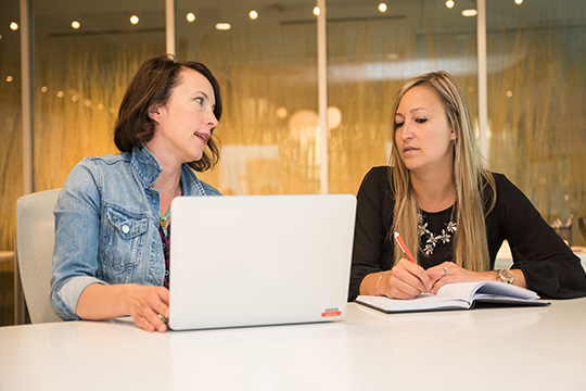two women working together