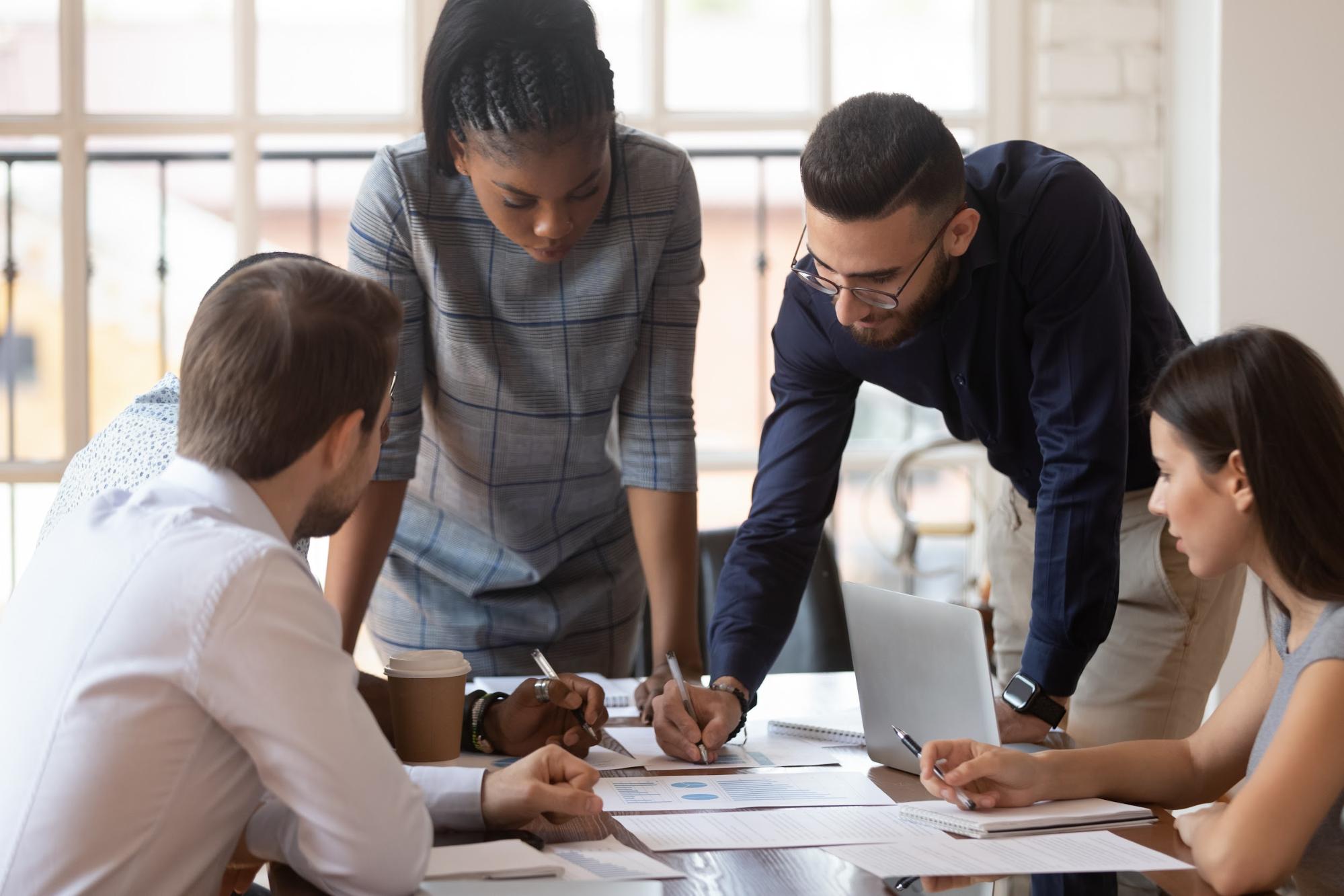 Group of five professionals collaborating around a table