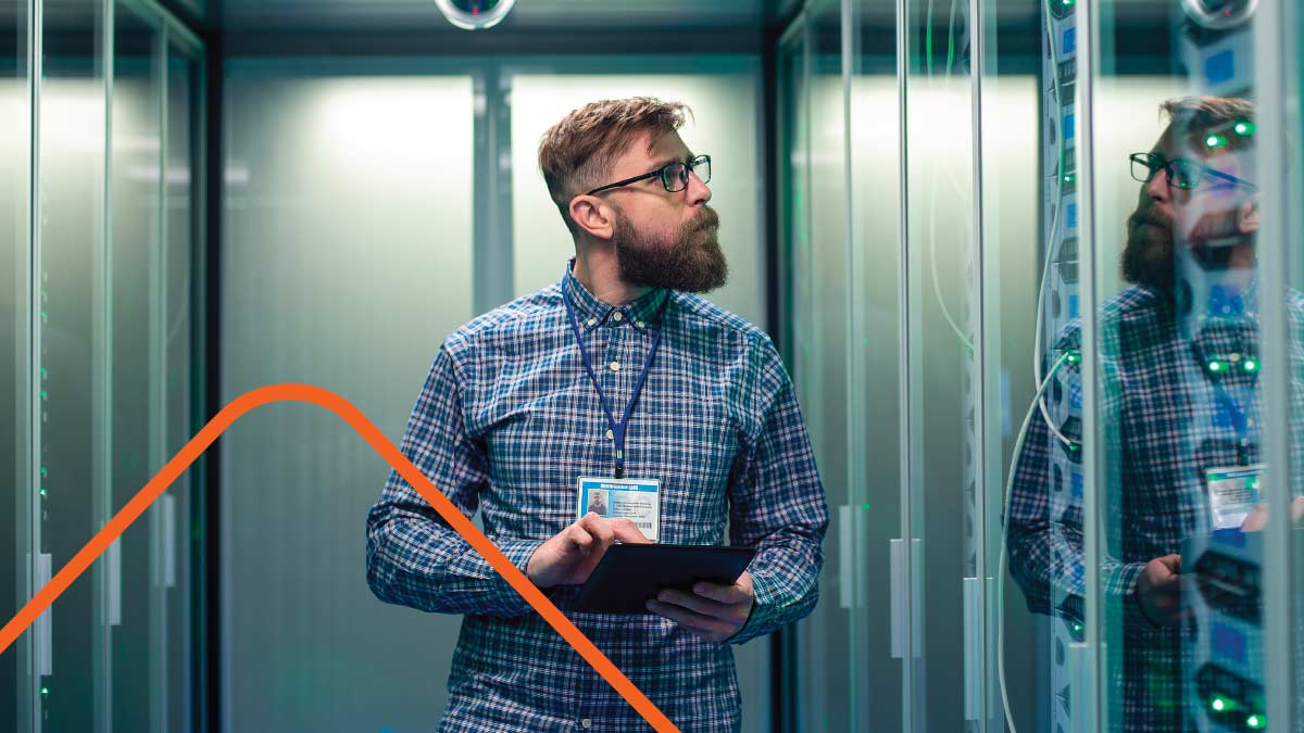 Man in blue shirt working in server room