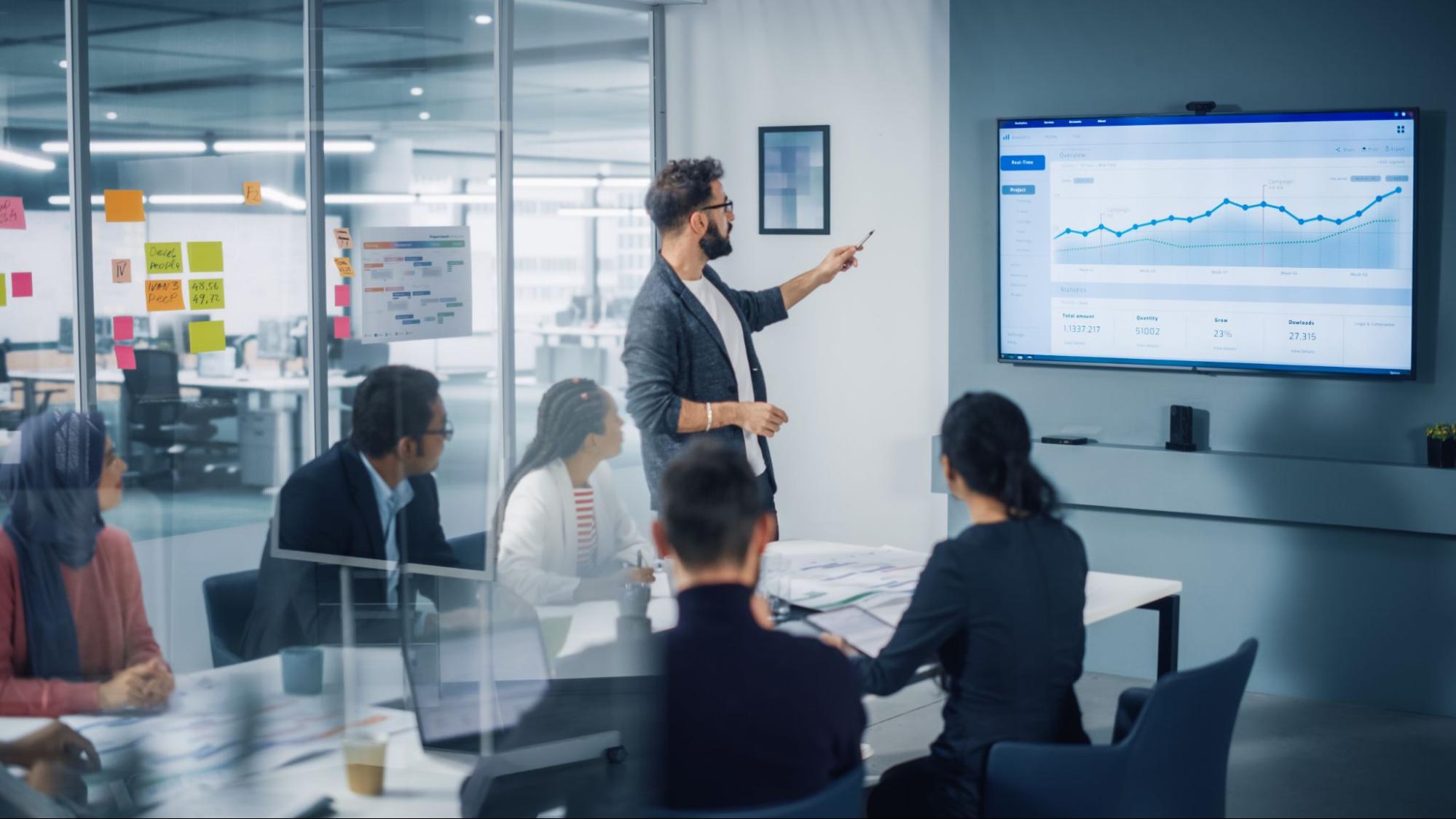 Man presenting data to colleagues