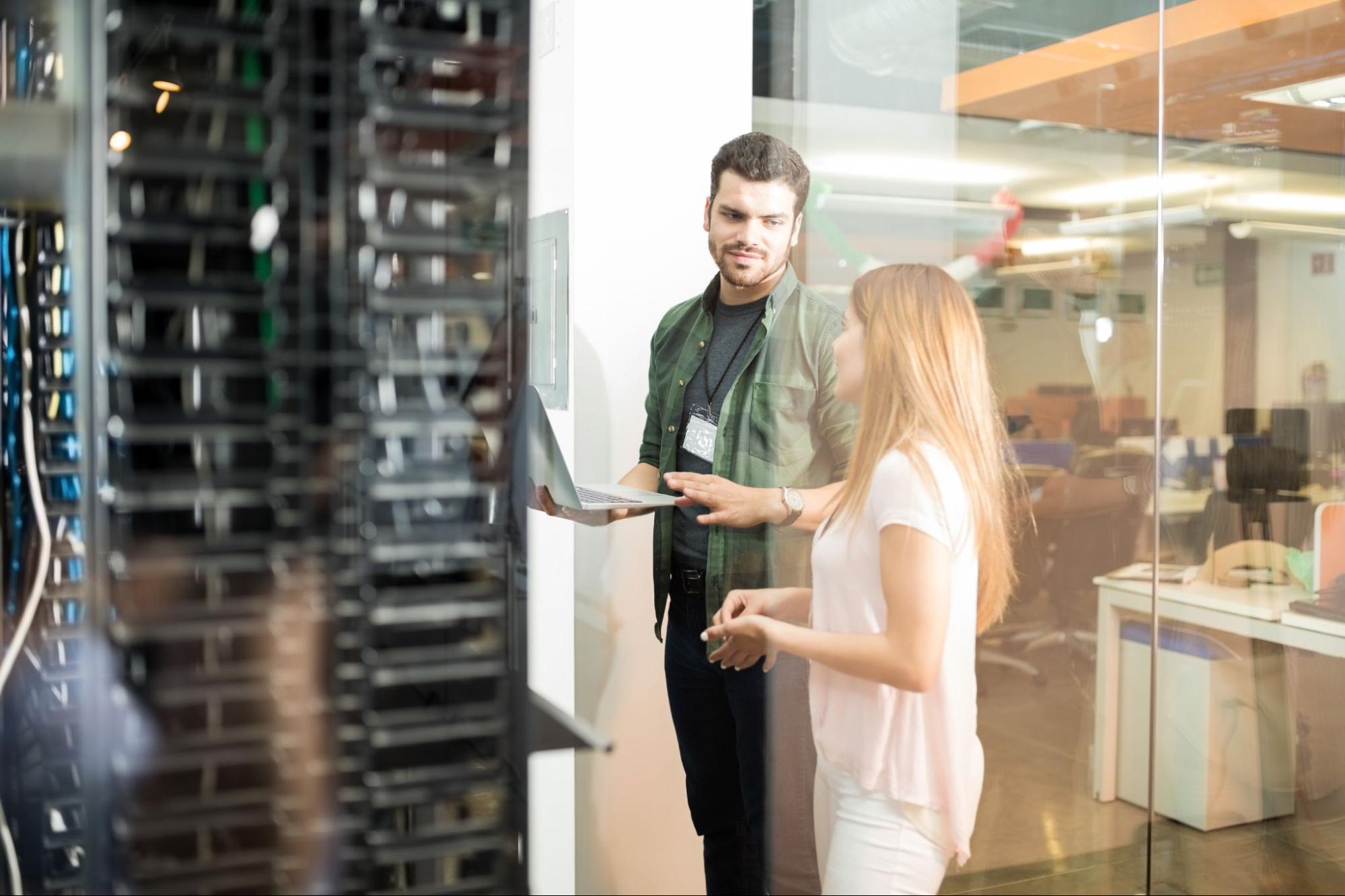 Two people discussing in server room