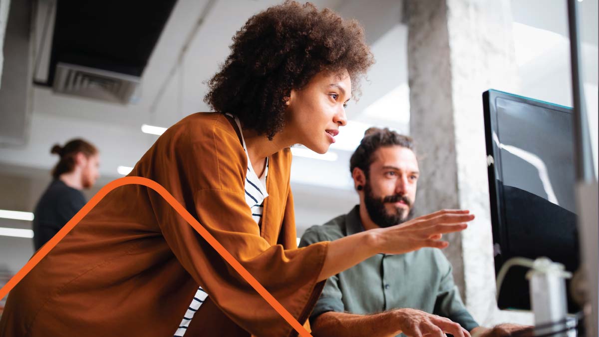 Woman and man looking at computer in office