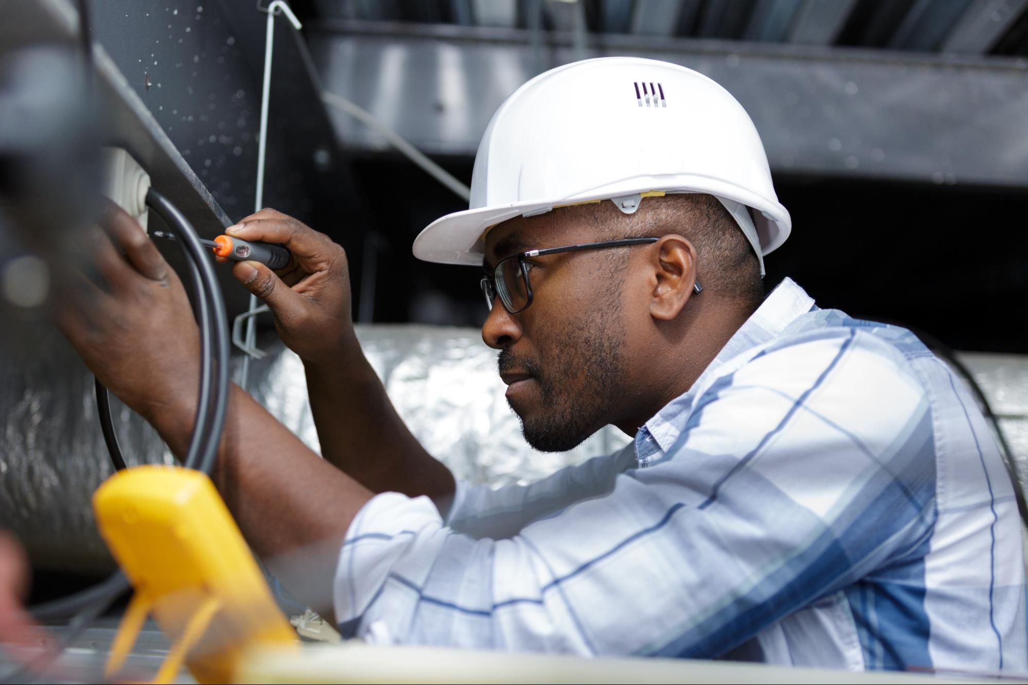 Person working with electrical wiring