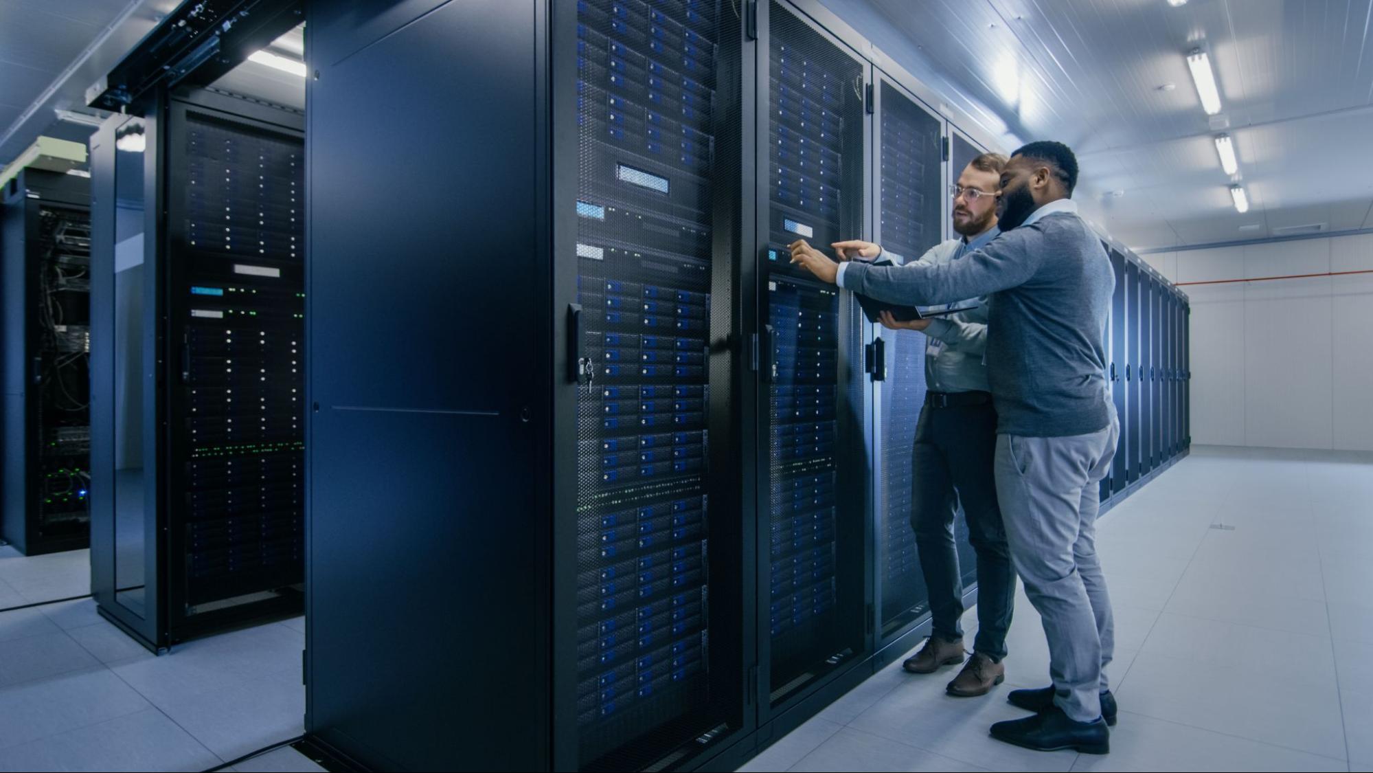 Two people working in server room