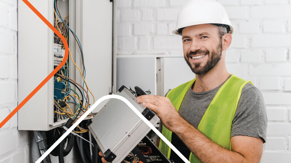 technician smiling with electrical toolbox